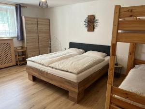 a bedroom with a bed and a bunk bed at Haus Mader 3 in Riscone