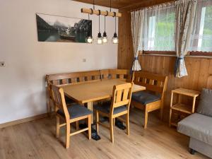 a dining room with a wooden table and chairs at Haus Mader 3 in Riscone