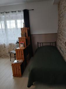 a bedroom with a bed and a book shelf at Gite La Ferme in Arinthod