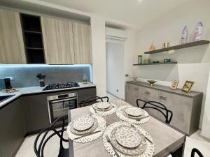 a kitchen with a table and chairs in a kitchen at Wake to Lake - Arona, Lago Maggiore in Arona +27 photos