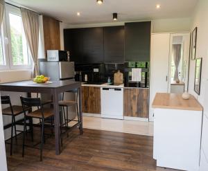 a kitchen with white appliances and a table with chairs at The Dream house in Tomaš