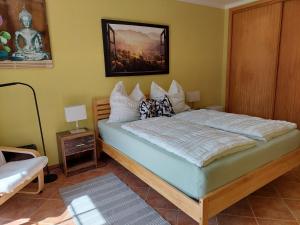 a bedroom with a bed with a picture on the wall at Villa Atlantico in Aljezur +49 photos