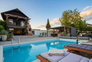 a swimming pool in front of a house at The Dream house in Tomaš