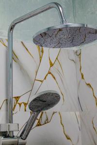 a shower head in a bathroom with a sink at Nice View Guest House & Restaurant in Ella +170 photos