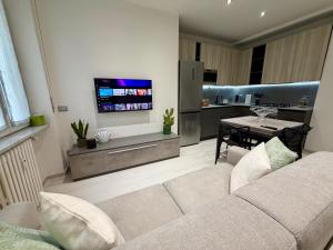 a living room with a couch and a dining room at Wake to Lake - Arona, Lago Maggiore in Arona