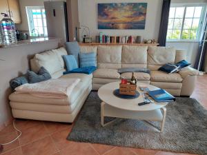 a living room with a couch and a coffee table at Villa Atlantico in Aljezur