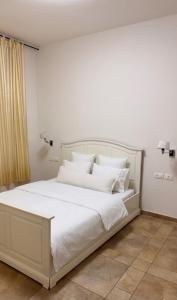 a white bed with white pillows in a bedroom at נורית בעמק in Gan Yoshiyya