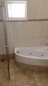 a white bath tub in a bathroom with a window at נורית בעמק in Gan Yoshiyya