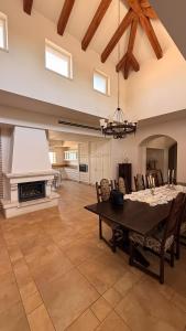 a large living room with a table and a fireplace at נורית בעמק in Gan Yoshiyya