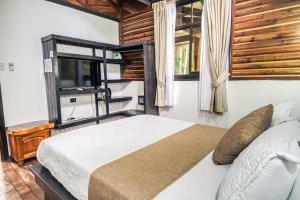 a bedroom with a large bed and a window at Casa Shaquir H -Luxury Villa with Private Pool & Stunning Views in Puerto Viejo