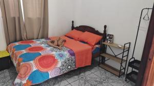 a person laying on a bed in a bedroom at Buganvilla No 4 Aire acondicionado in Quepos