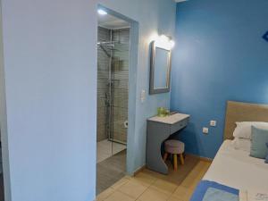 a bathroom with a shower and a bed and a sink at Celeste Deluxe Apartments in Skala Potamias +72 photos