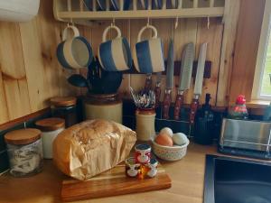 a kitchen counter with a loaf of bread and utensils at Bothan na Mara in Valtos +13 photos