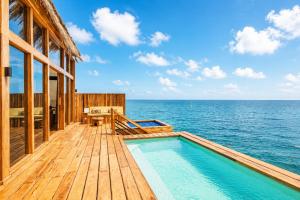 a house on the beach with a swimming pool at Kwanza Resort By SUNRISE in Kizimkazi