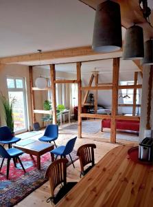 a living room with a table and chairs and a bed at Krusenhofilona in Krusendorf