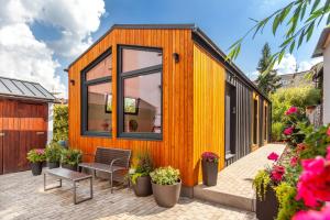 a tiny house with a large window on a patio at Pension Skylark in Pardubice