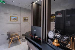 a room with a desk with a clock and a bike at Bazaar Inn Boutique & Luxury Rooms in Skopje