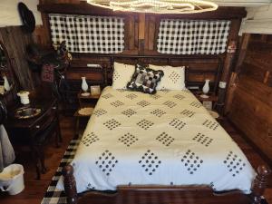a bedroom with a bed and a chandelier at The Stable at Windmill Ridge Farm in Fredonia