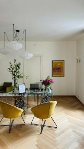 a dining room with chairs and a table with flowers at Albergo Al Castello in Gavi