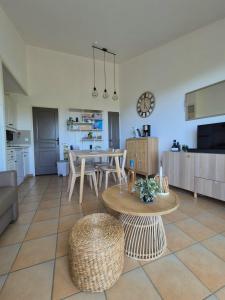 a kitchen and a living room with a table and chairs at Les Restanques - Grimaud in Grimaud