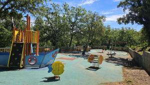 a park with a playground with a play equipment at Les Restanques - Grimaud in Grimaud