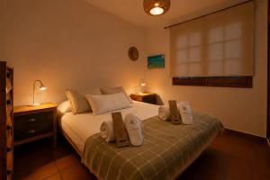 a bedroom with a bed with two towels on it at Deluxe Mogán Beach Apt 1 in Puerto de Mogán