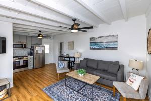 a living room with a couch and a table at Steps to the pier! in San Clemente
