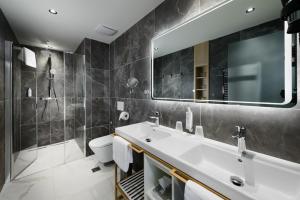 a bathroom with a sink and a toilet and a mirror at SOPHIA PALACE Hotel Budapest in Budapest +109 photos