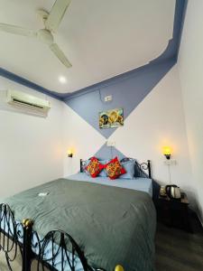 a bedroom with a bed with blue and white walls at Old Skool Udaipur - 20 Meter From Lake in Udaipur