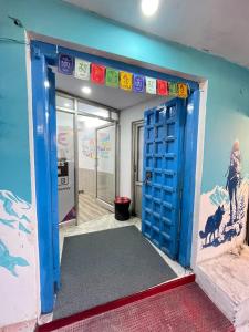 an open door in a room with a blue wall at Old Skool Udaipur - 20 Meter From Lake in Udaipur +56 photos