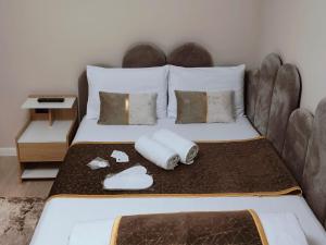 a bedroom with a bed with two towels on it at Delfinului Retreat in Ovidiu