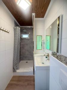a white bathroom with a shower and a sink at Hotel Kenny & Henry in Cuxhaven +65 photos
