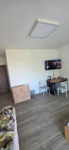 a room with a bed and a desk and a tv at Útulný klidny pokoj A in Radošovice