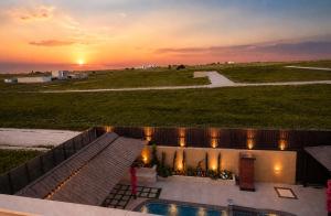 a view of a sunset from a building with a pool at WesamFarm in Amman