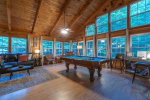 a living room with a pool table in it at Cozy Cabin Retreat Near Helen Hot Tub Fireplace in Sautee Nacoochee