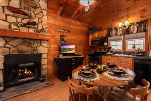 a kitchen with a table and a fireplace in a cabin at Cozy Cabin Retreat Near Helen Hot Tub Fireplace in Sautee Nacoochee