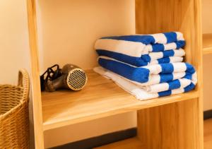a stack of towels on a shelf in a room at Sansara Maldives - The Untouched South, Easy Access via Sri Lanka in Meedhoo +66 photos
