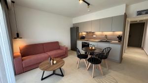 a living room with a couch and a table and chairs at Almondo Suites in Amigdhaleón