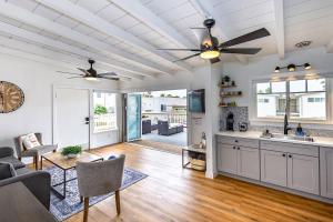 a kitchen and living room with a ceiling fan at Steps to the pier! in San Clemente