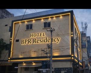 a sign on the side of a building with lights at HOTEL BPR RESIDENCy in Hyderabad