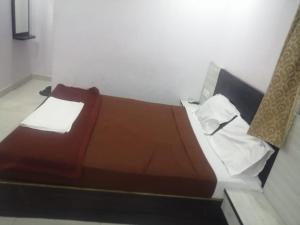 a bed in a white room with at HOTEL BPR RESIDENCy in Hyderabad