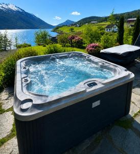 a jacuzzi tub with a view of a lake at Villa Lilleheim in Breim