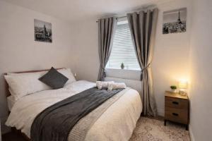 a bedroom with a large bed and a window at Fully Equipped Homely Heaven in Houghton le Spring