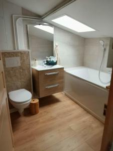 a bathroom with a toilet and a tub and a sink at Ma Bulle Confort in Pouzauges +11 photos