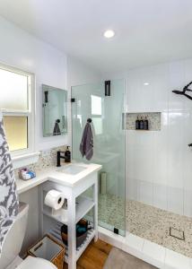 a bathroom with a shower and a sink at Steps to the pier! in San Clemente