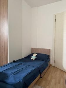 a teddy bear sitting on top of a bed at Apartman HODŽIĆ in Sarajevo