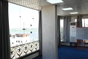 a room with a balcony with a large window at فندق شهرزاد - Shahrazad Hotel in Banī ‘Aţīyah