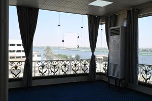 a room with a balcony with large windows at فندق شهرزاد - Shahrazad Hotel in Banī ‘Aţīyah