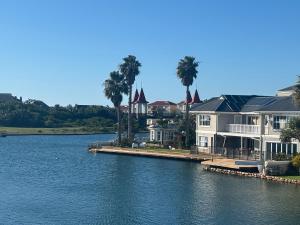 a large house on the water next to a lake at Paradise Cove Marina in Jeffreys Bay