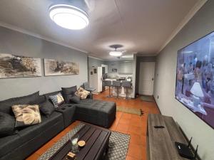 a living room with a couch and a table at Paradise Cove Marina in Jeffreys Bay